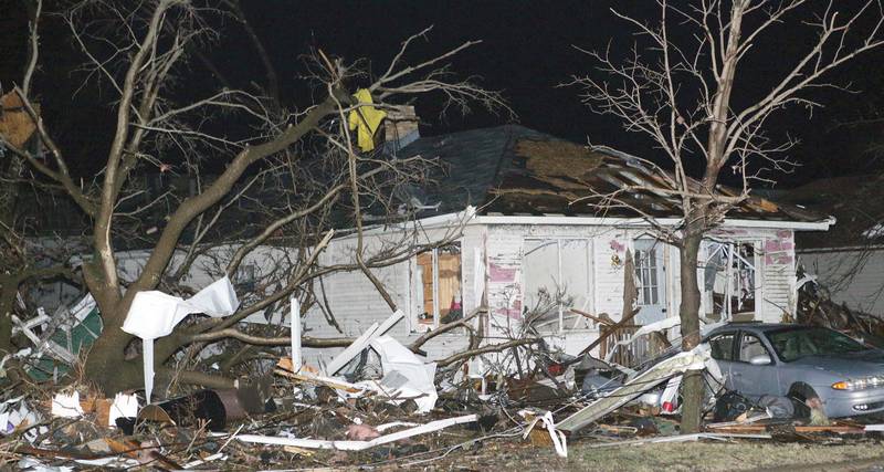 Debris sits in the yard of a home damaged by a tornado that passed through the Village of Naplate on Tuesday, Feb. 28,  2017 in Naplate.