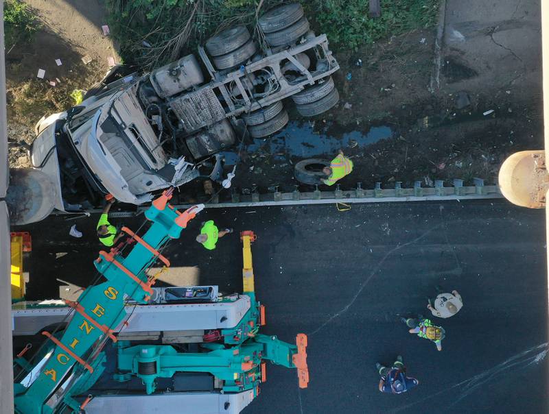 An aerial view showing emergency crews working the scene of a semi truck that struck the overpass of Illinois Route 251 and Interstate I-80 on Friday, Sept. 26, 2025 in Peru. The driver of the semi had to be extricated. Illinois State Police, Peru Fire and EMS,  Senica Towing and Illinois Department of Transportation were all on the scene. The incident happened in a construction zone on Interstate I-80 shortly after 7:15a.m.