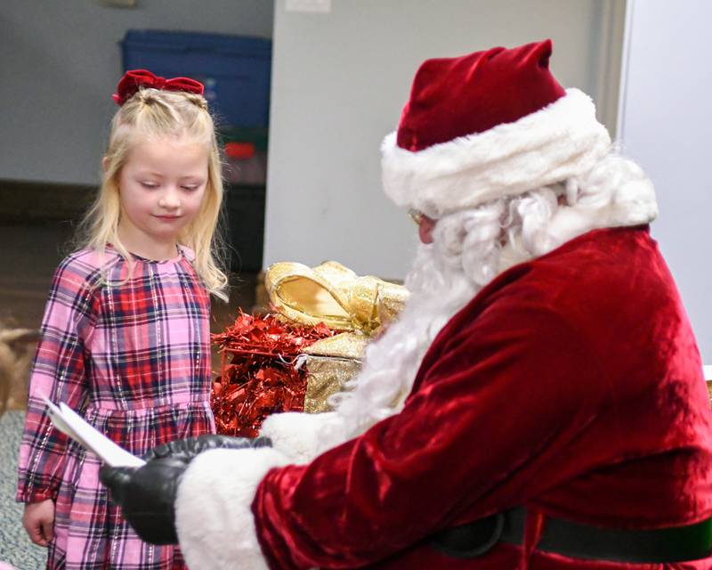Caoimhe Shields, 5, of La Grange goes over her Christmas list with Santa during the breakfast with Santa event on Sunday Dec. 15, 2024, held at the La Grange Park District Recreation Center.