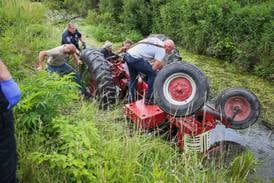 Firefighters rescue man pinned under a tractor in water near Harvard 