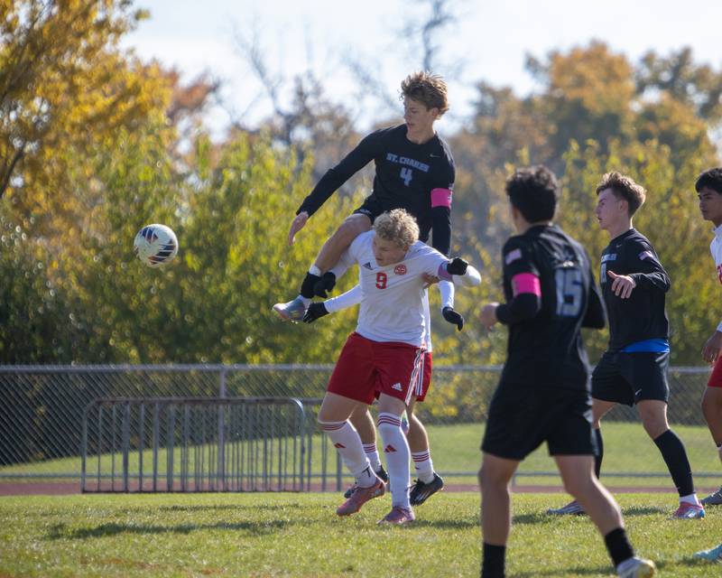 St. Charles North's Ashton Goettel jumps for the ball with South Elgin's Matthew Lipp at the Class 3A Sectional Final on Saturday, Nov. 1,2025 in South Elgin.