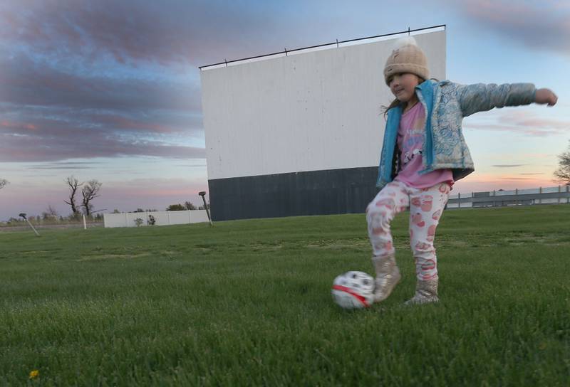 Rowyn Pitas of Maple Park, practices kicking her soccer ball as the sun sets behind the Route 34 Drive-In screen on Friday, April 19, 2024 in Earlville.