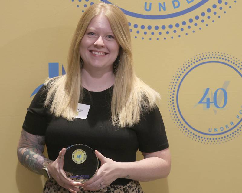 Dani Holland poses with her 40 Under Forty award during the Illinois Valley Chamber of Commerce Champions of Change Awards Night on Wednesday, May 6, 2026 at the Westclox Event Center in Peru.