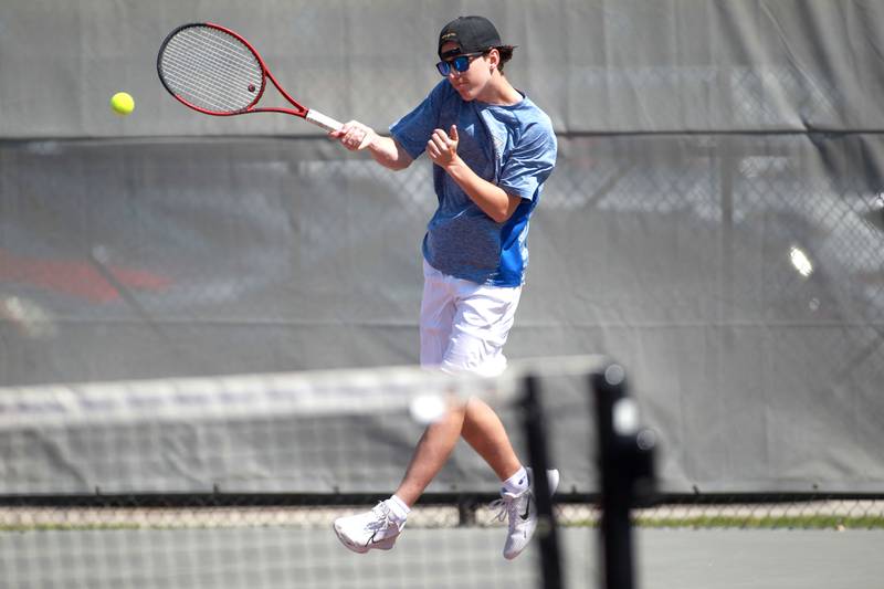 Woodstock’s Devon Oliveira returns the ball during a doubles match with partner Liam Hanson (not pictured) in the state championship preliminaries at Palatine High School on Thursday, May 23, 2024.