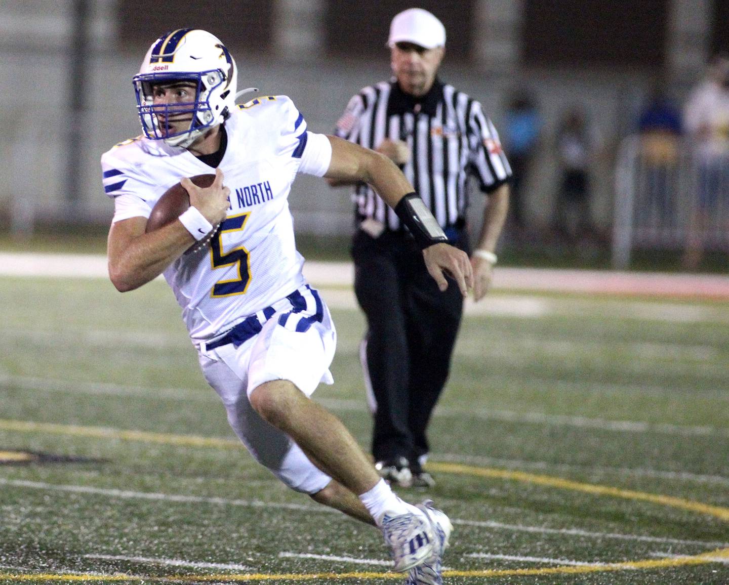 Wheaton North quarterback Mark Forcucci keeps the ball during a game at Batavia Friday, Sept. 10, 2021.