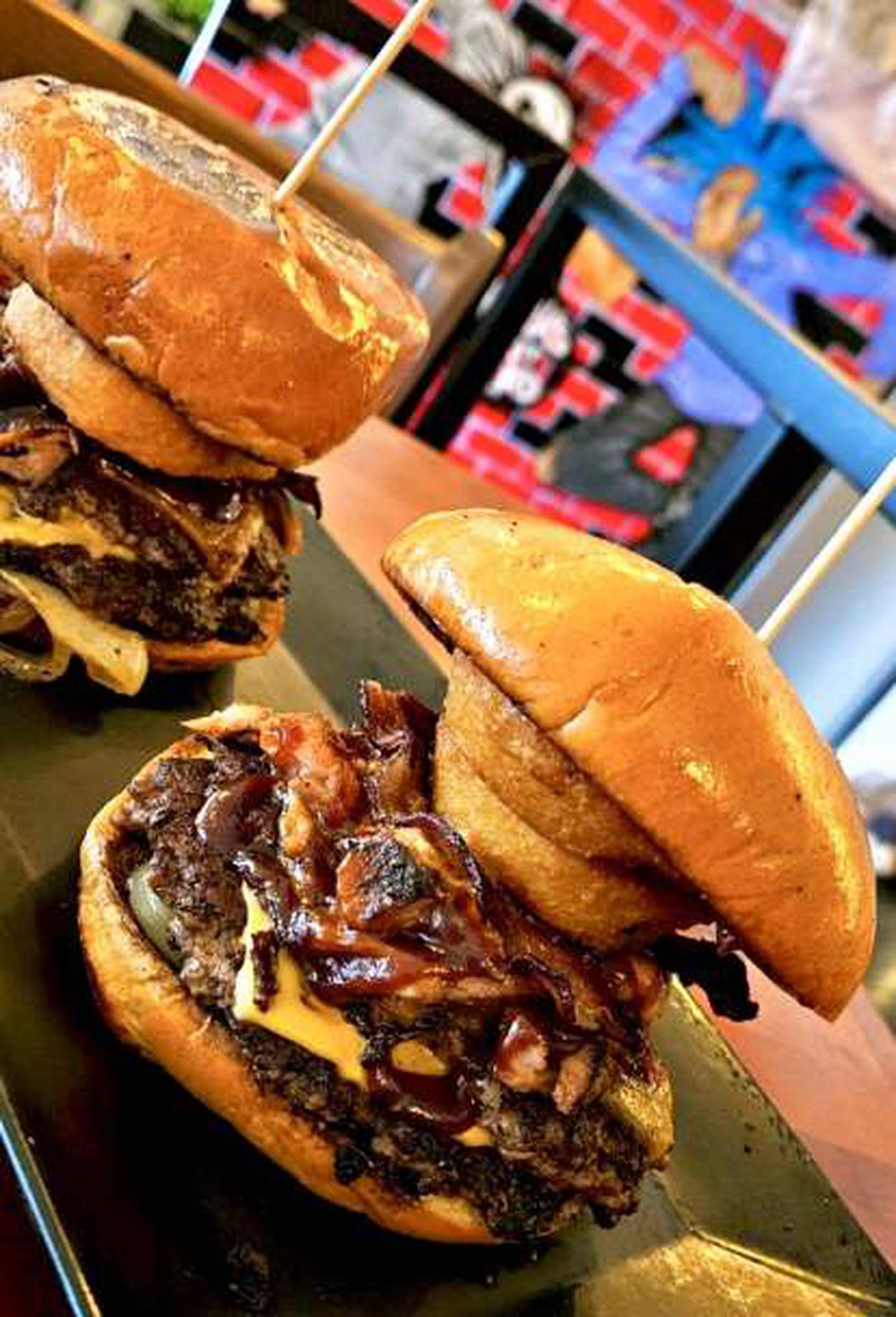 Burgers from Legit Dogs & Ice feature two Angus smash patties on brioche buns with myriad toppings.