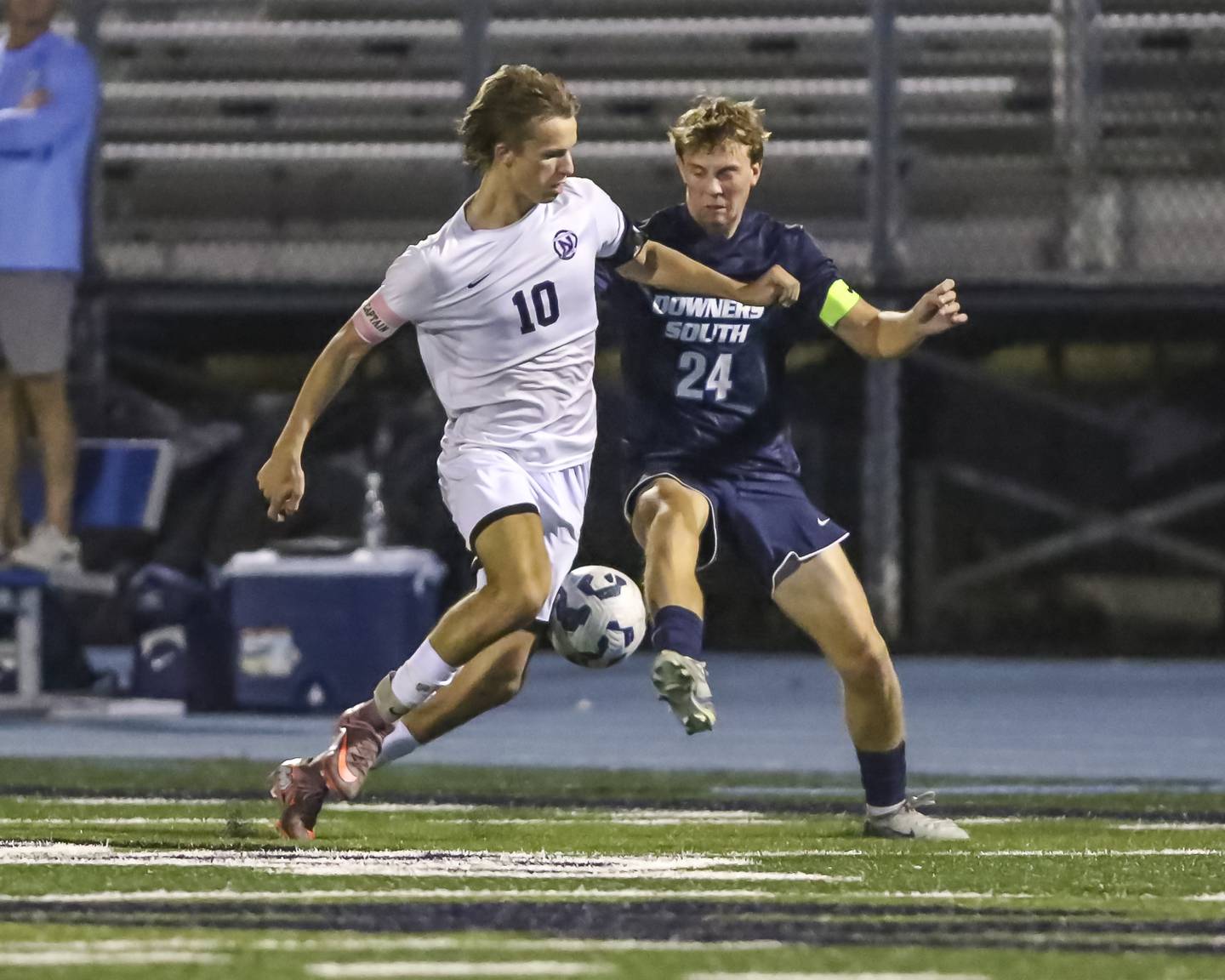 Downers Grove North's Oliver Davies (10) and Downers Grove South's Connor Szopko (24) battle for the ball during soccer match between Downers Grove North at Downers Grove South. Oct 2, 2025.