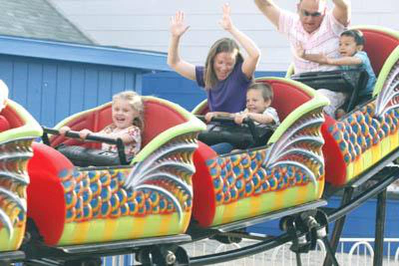 Sarah and C.J. Polotto (center car) ride the roller coaster Friday during the carnival at Genoa Days. “He did really well,” said Sarah about her 4-year-old son, C.J. “He was trying to put his hands up.” Genoa Days wraps up Saturday. EMILY OLSON | For the Daily Chronicle