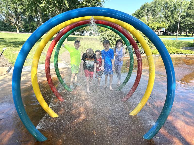 Gadsen Steele, 7, Wells Hintzsche, 8, Ronan Steele, 3, Oren Steele, 6, and Willa Hitchcock, 8, run through one of the water features at the Oregon Park District's Splash Park at Park West on Monday, July 28, 2025.