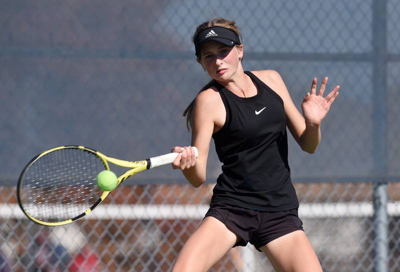 Fenwick’s Lily Brecknock returns the ball during the Class 1A singles state championship match at the girls state tennis meet in Buffalo Grove Saturday.