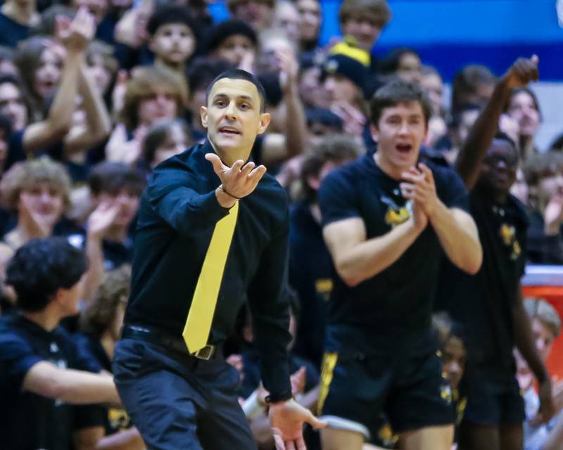 Hinsdale South's head coach Mike Belcaster yells out instructions with Brendan Savage (30) in the background during basketball game between Hinsdale South at Downers Grove South. Dec 1, 2023.