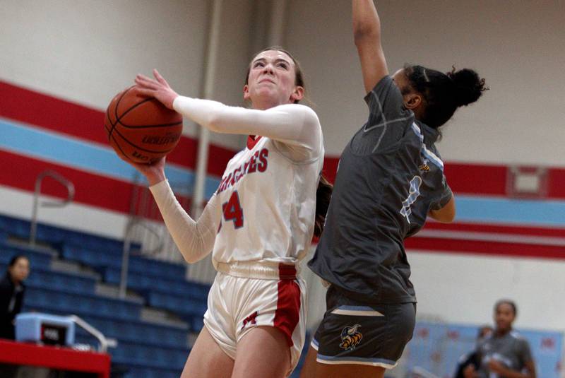Marian Central’s Juliette Huff takes a shot against Rockford Guilford in varsity girls basketball Saturday at Landers Pavilion on the campus of Marian Central High School in Woodstock.