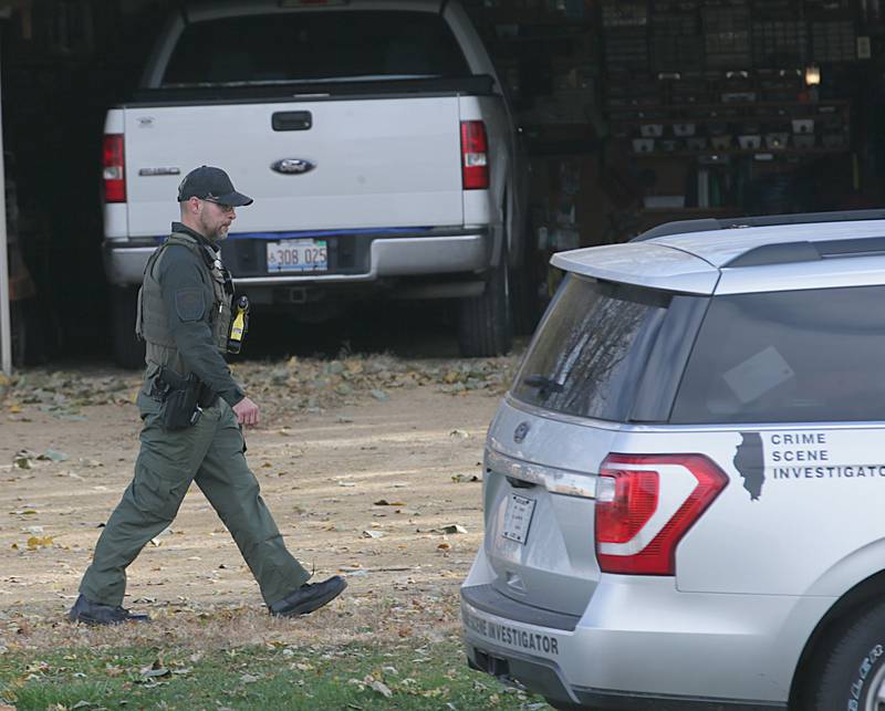 An Illinois State Police Crime Scene Investigator officer walks the scene of an incident in the 200 block of E. Long Street on Monday, Oct. 24, 2022 in Ohio, Ill. A suspect is in custody and there is no longer a threat to the community, the Bureau County Sheriff’s Office told Ohio Community School District.
