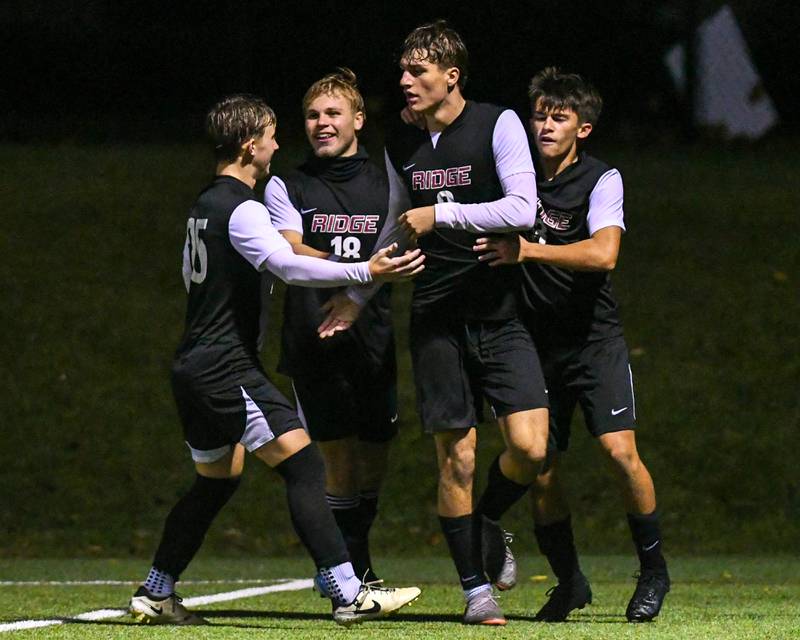 Prairie Ridge's Henry Knoll, second from right, celebrates with team after scoring his second goal of the night while taking on Benet Academy during the class 2A super sectional soccer match on Tuesday Nov. 5, 2024, held at Wheaton Academy in West Chicago while taking on Benet Academy.