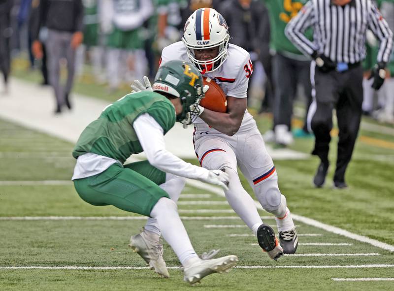 Oswego's Ammar Banire (34) runs the ball during the varsity football second-round 8A playoff game between Oswego and Lane Tech on Saturday, Nov. 8, 2025 in Chicago.