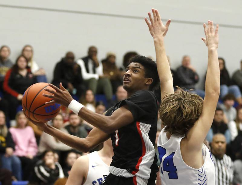 Huntley's Bryce Walker drives past Burlington Central's Bennek Braden during a Fox Valley Conference boys basketball game on Friday, Dec. 15, 2023, at Burlington Central High School.