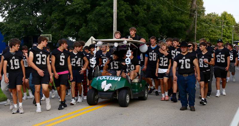 The Kaneland Varsity Football Team marches in the Kaneland Homecoming Parade in Kaneville on Wednesday, Sept. 14, 2022.