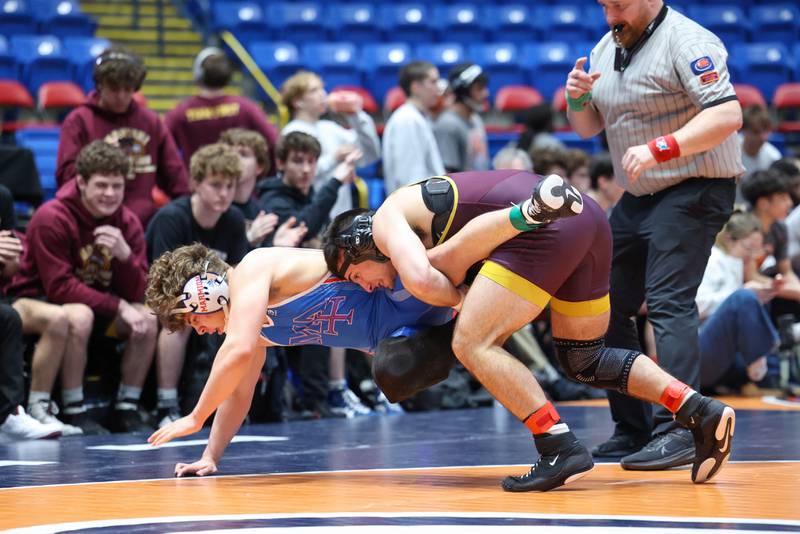 Montini's Santino Tenuta, right, takes down Marmion Academy's Grayson Garcia in the 165-pound match during Marmion Academy's victory over Montini in the IHSA Class 3A Dual Team State championship on Saturday, Feb. 28, 2026.