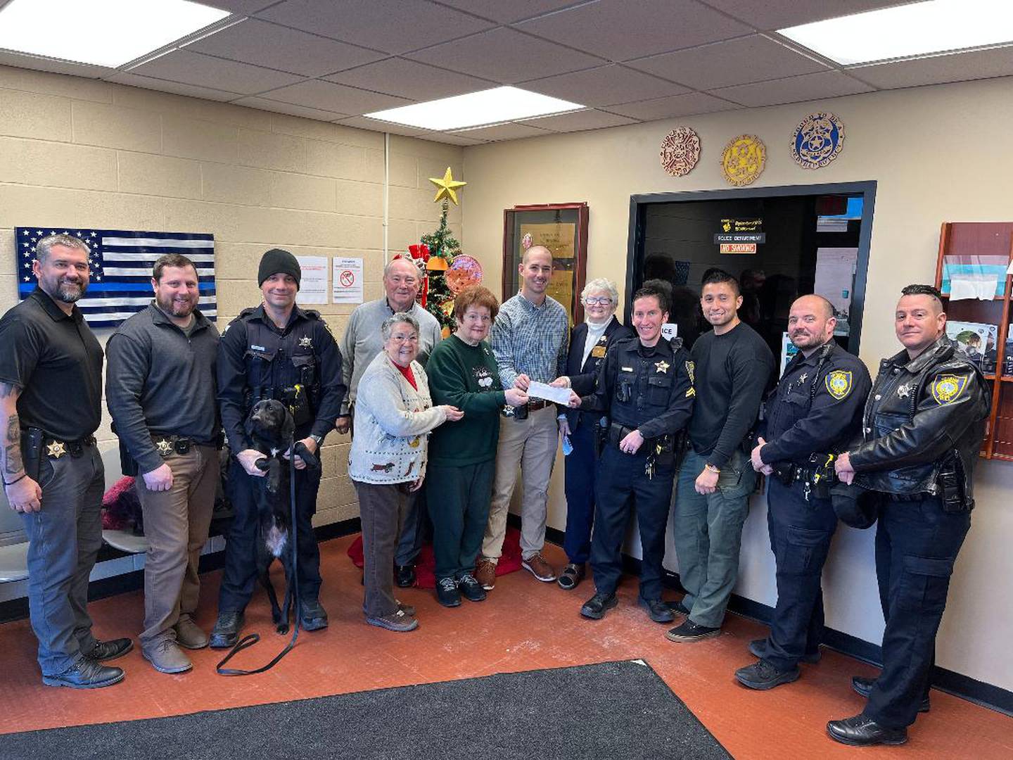 A $500 check was presented to Cpl. Det. Matthew Najdeenovich and other members of the Ottawa Police Department by Elk members Lynne Schlink, Sara Smith, Kay Olson and Tim Creedon to help provide Christmas gifts for the children in need in the Ottawa area.
