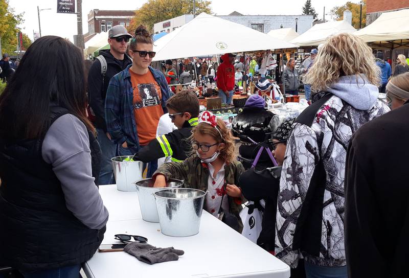 Children make their rounds trick or treating Saturday, Oct. 16, 2022, in downtown Oglesby during Harvest Fest