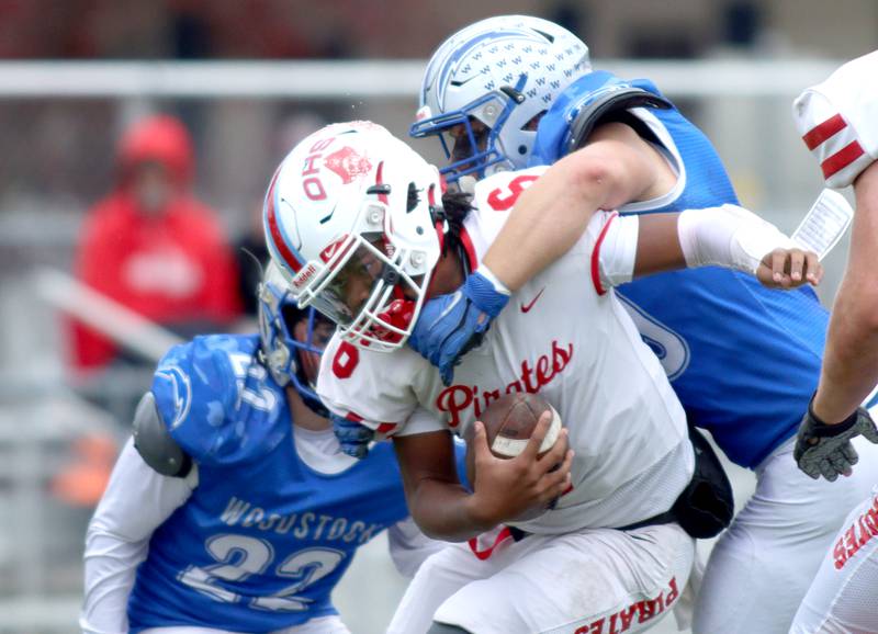 Woodstock’s Cooper Pajich, right, overtakes Ottawa’s quarterback Colby Mortenson for a sack in varsity football at Larry Dale Field on the campus of Woodstock High School Saturday.