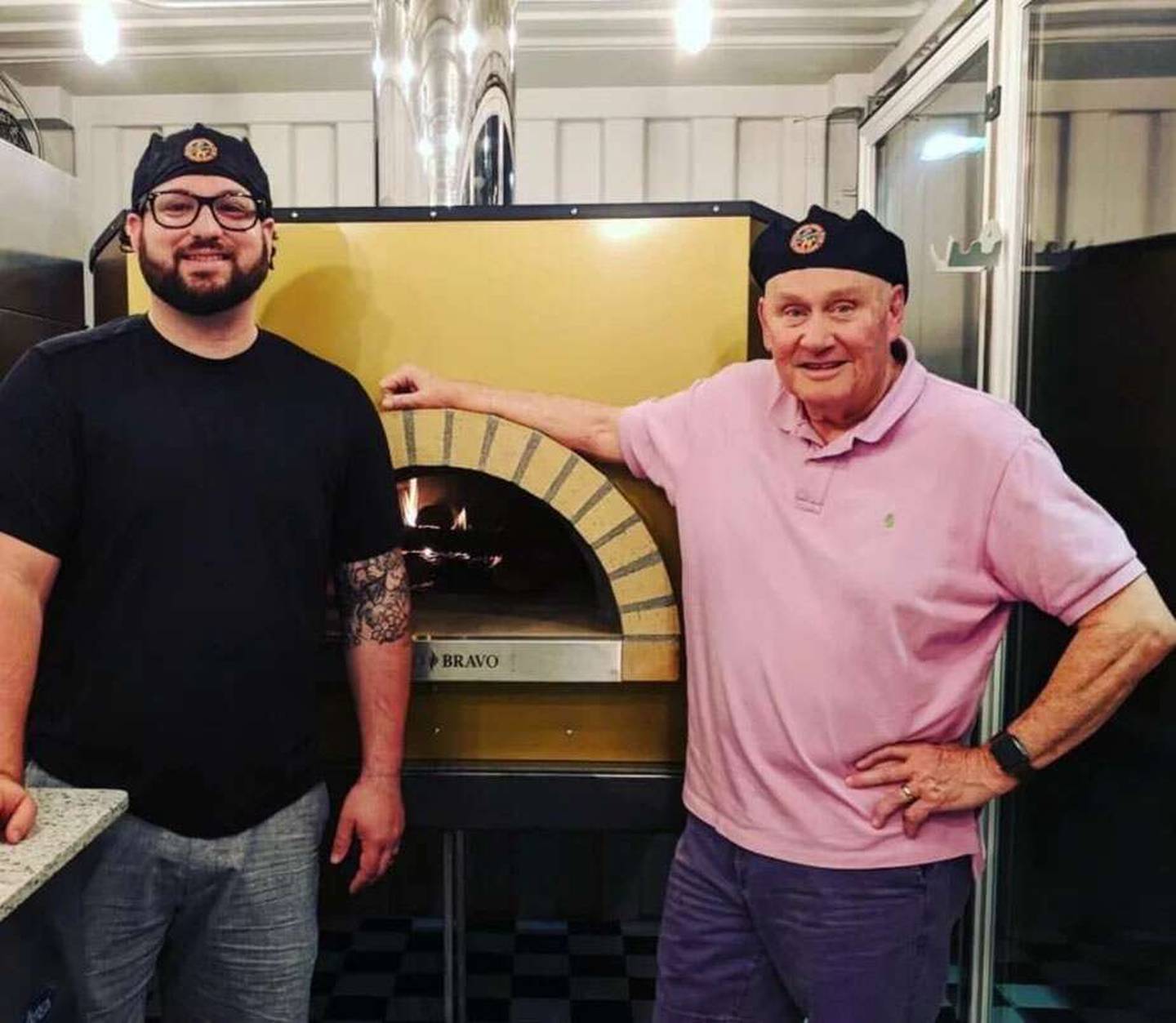 Billy Bricks is celebrating 20 years of serving wood-fired brick-oven pizza in the suburbs. The company is currently helmed by CEO Ric Gruber, left, and was founded by his dad, Bill Wilson.
