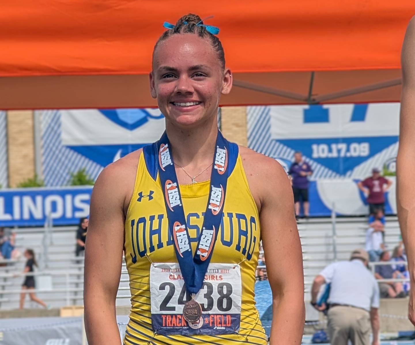 Johnsburg's Hope Klosowicz smiles on the awards stand after finishing fourth in the Class 2A 400-meter run during the IHSA Girls Track and Field State Meet on Saturday, May 23, 2026, at Eastern Illinois University in Charleston.