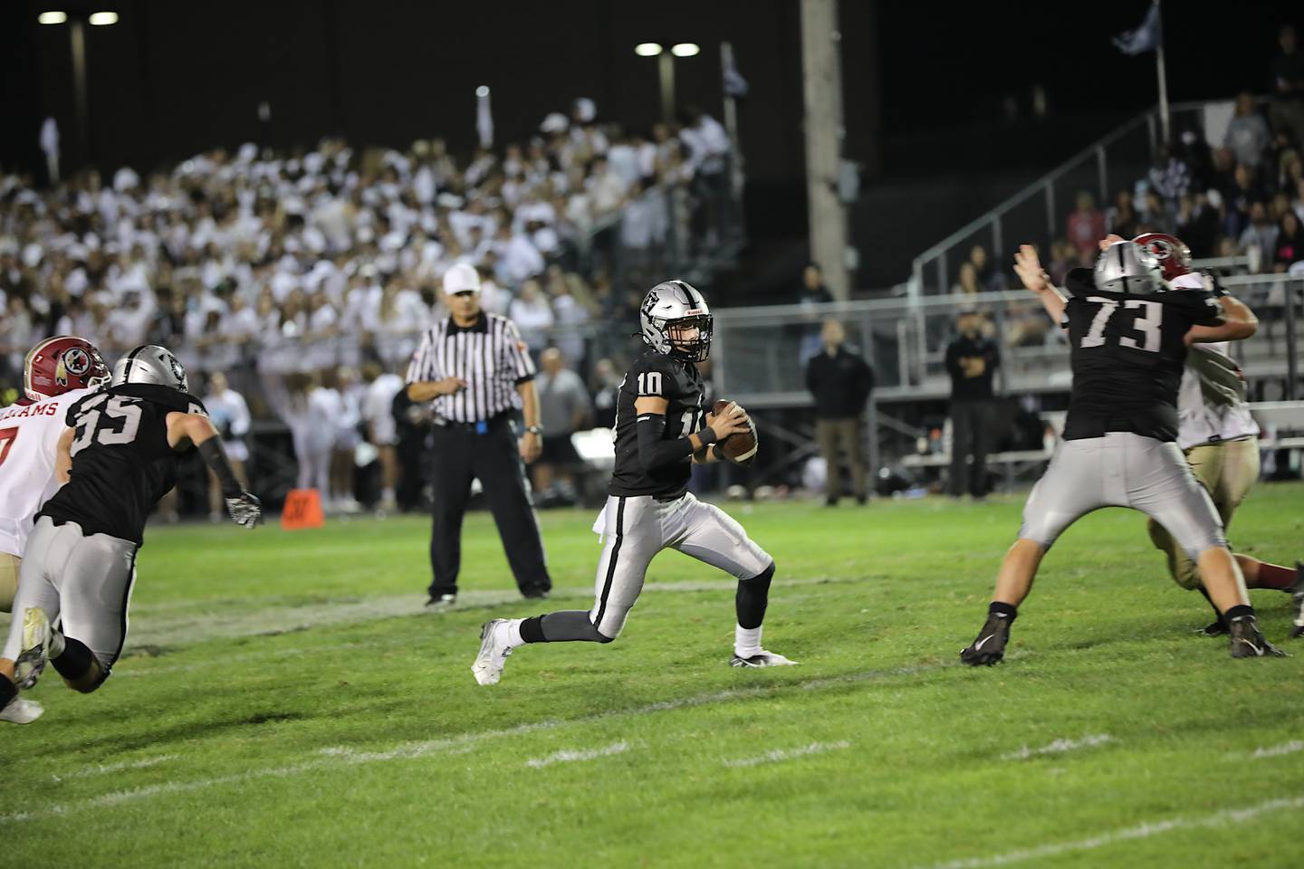 Kaneland's Troyer Carlson scrambles Friday night in a 49-35 loss to Morris. Carlson threw for 320 yards and four touchdowns and ran for 32 yards and a TD.