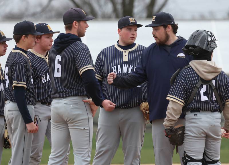 Hiawatha head coach Steven Kenyon meets with his infield at the mound Thursday, April 17, 2025, during their game against Parkview Christian Academy at Hiawatha High School in Kirkland.