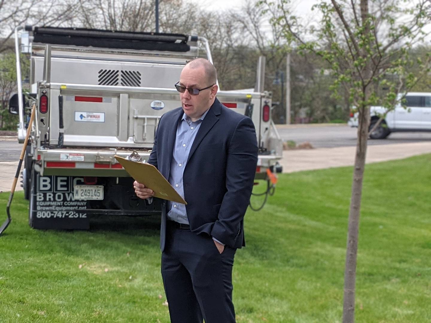Oswego Village President Ryan Kauffman reads an Arbor Day proclamation as he stands next to a newly planted Summer Elixir Elm in front of Oswego Village Hall on Arbor Day, April 25.