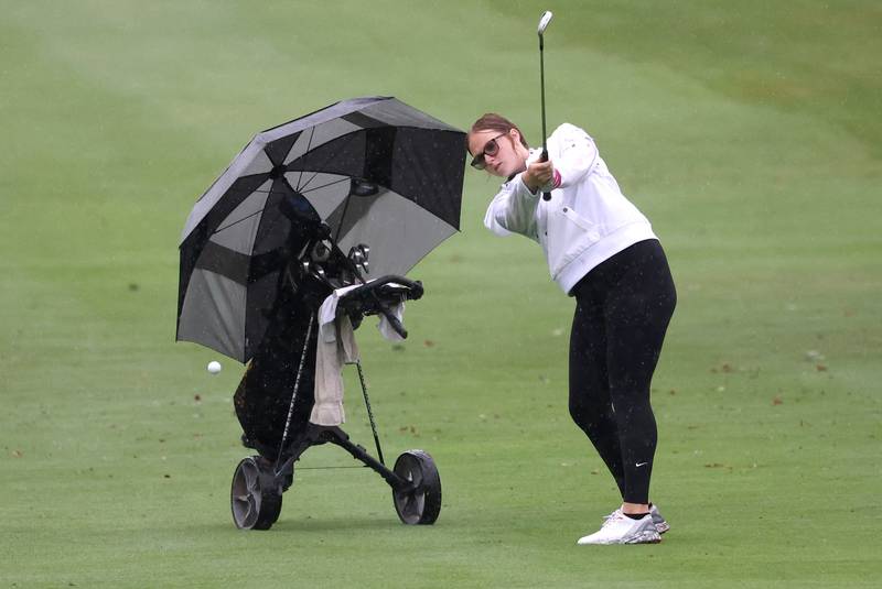 Sycamore DeKalb co-op’s Taya Johnson hits a shot from the second fairway Tuesday, Sept. 24, 2024, during the Interstate 8 girls golf tournament at the Sycamore Golf Club.