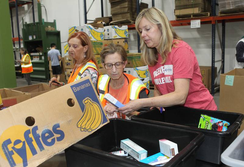 Barbara Woltanski, of Arlington Heights, Sue Shamberg, of Vernon Hills and Kristin Berdelman, of Highland Park work together to sort donated products from Walgreens at the Northern Illinois Food Bank on August 19th in Lake Forest. The North Suburban Center recently celebrated it’s one-year anniversary at this location.  
Photo by Candace H. Johnson for Shaw Local News Network