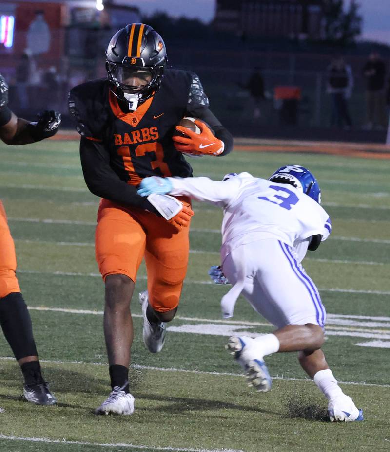 DeKalb's Davon Grant gets by Phillips' Ashton Williams Friday, Sept. 5, 2025, during their game at DeKalb High School.