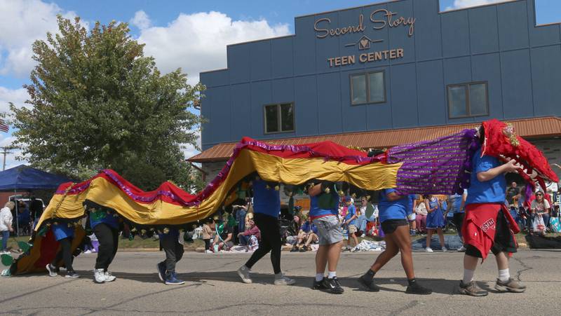 Teens with the Second Story Teen Center perform a dragon dance in front of the new Second Story Teen Center during the 54th annual Homestead Festival parade on Saturday, Sept. 6, 2025 in Princeton.