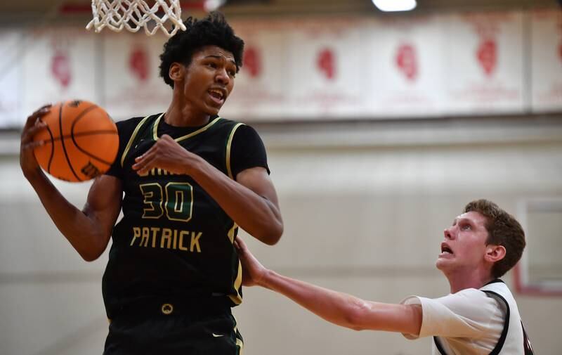 Benet’s Colin Stack defends last St. Patrick’s Nevaeh Hawkins (30) comes down with a rebound during a game on January 17, 2025 at Benet Academy in Lisle.