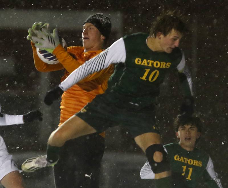 Timothy Christian's Peter Buikema grabs the ball as Crystal Lake South's Nolan Getzinger tries to head the ball into the goal during the IHSA Class 2A Grayslake Central Supersectional soccer match on Tuesday, Oct. 31, 2023, at Grayslake Central High School.