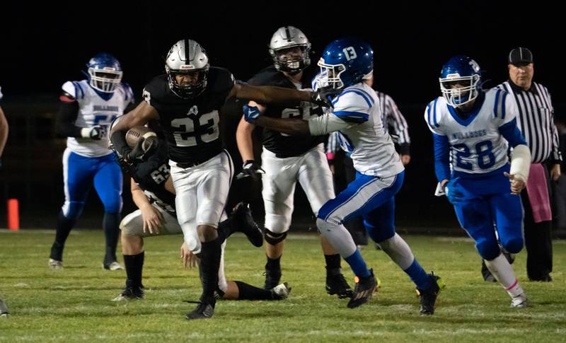 Kaneland’s Aric Johnson (23) carries the ball against Riverside Brookfield's Marques Turner (13) during a 6A playoff football game at Kaneland High School in Maple Park on Friday, Oct 28, 2022.\