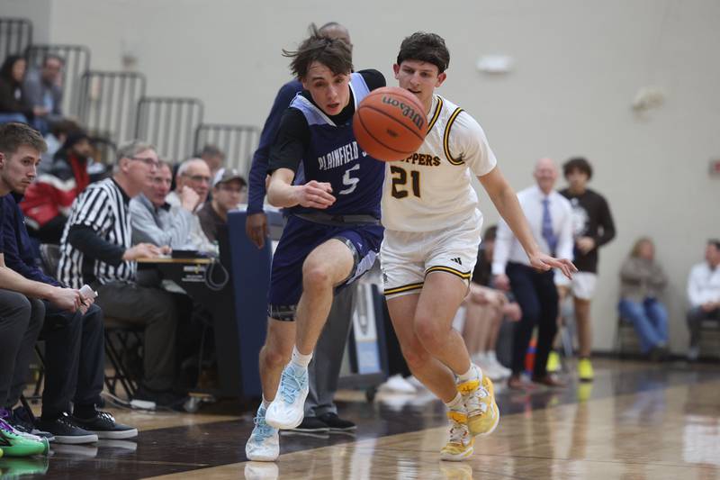 Plainfield South’s Devin Tyda loses the ball after a push foul by Joliet Catholic’s Owen Wiers on Wednesday, Jan. 17th, 2024 in Joliet.
