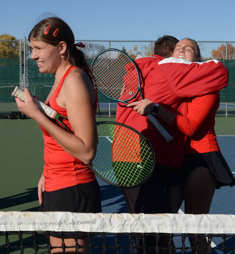 Benet Academy’s Clare Lopatka, left, and Shane Delaney, hugging coach Michael Hand, celebrate after winning the Class 1A doubles championship match of the girls state tennis tournament at Hersey High School on Saturday, Oct. 26, 2024 in Arlington Heights.