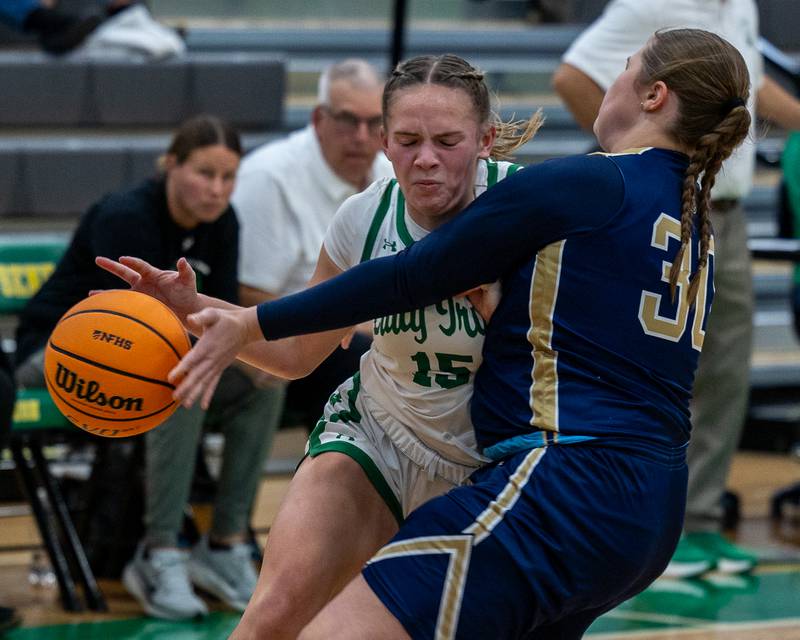 Kylee Rowley (15) of Seneca drives into lane and collides with Madison Kozlowski (30) of Marquette on Monday, November 17, 2025 at Seneca High School in Seneca.