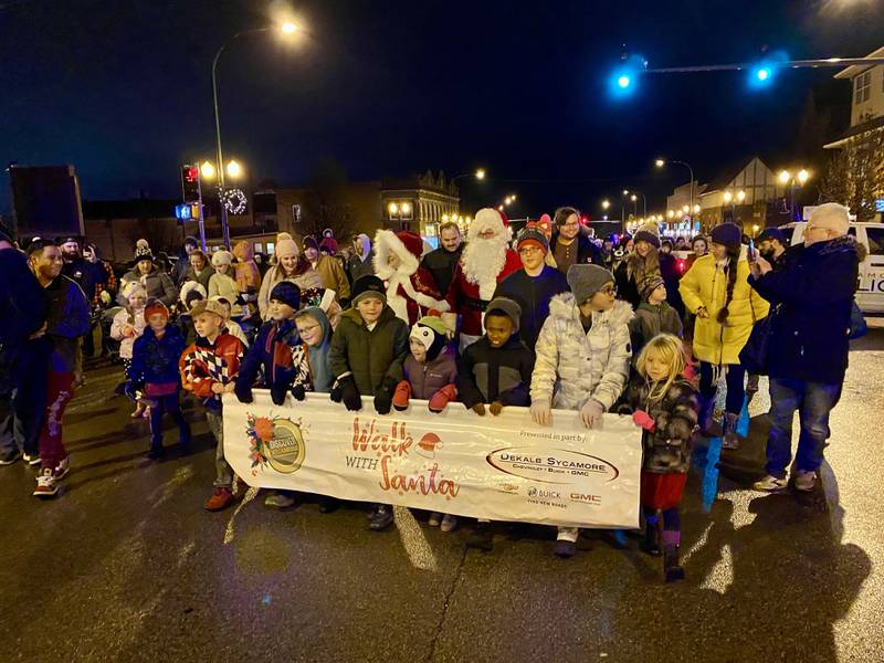 Children and families excited to meet the man from the North Pole marched along State Street with Santa Claus and Mrs. Claus in downtown Sycamore for Discover Sycamore's annual Walk with Santa on Friday, Dec. 1, 2023.