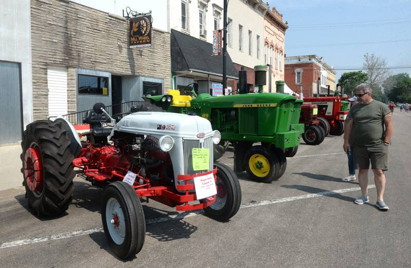 Greg and Judy Haider of Davenport, Iowa look at Trevor and Roger Knutti's 1950 Ford 8N tractor at the Milledgeville car and tractor show on Sunday, June 4.