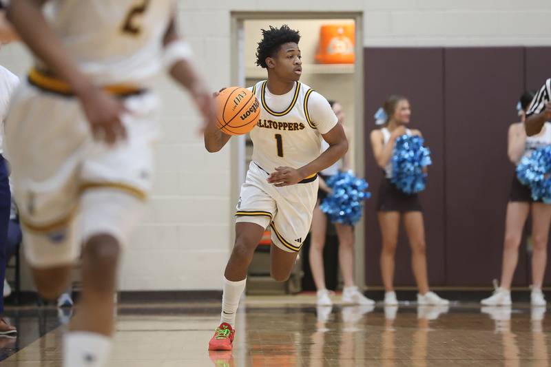 Joliet Catholic’s Jayden Armstrong works the ball upcourt against Elmwood Park in the Class 3A Joliet Catholic Regional semifinal game on Wednesday, Feb. 25, 2026 in Joliet.