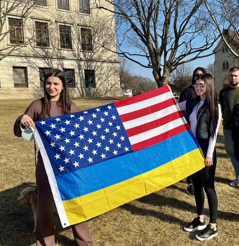 Veronika Chernova and Polina Kuptsova hold a flag during a vigil in support of Ukraine in Dixon on March 13, 2025.
