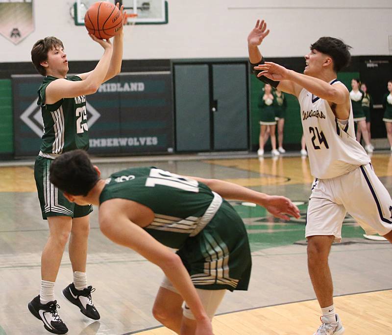 St. Bede's Logan Potthoff shoots a jump shot over Marquette's Taylor Waldron in the Class 1A Regional semifinal on Wednesday, Feb. 22, 2023 at Midland High School.