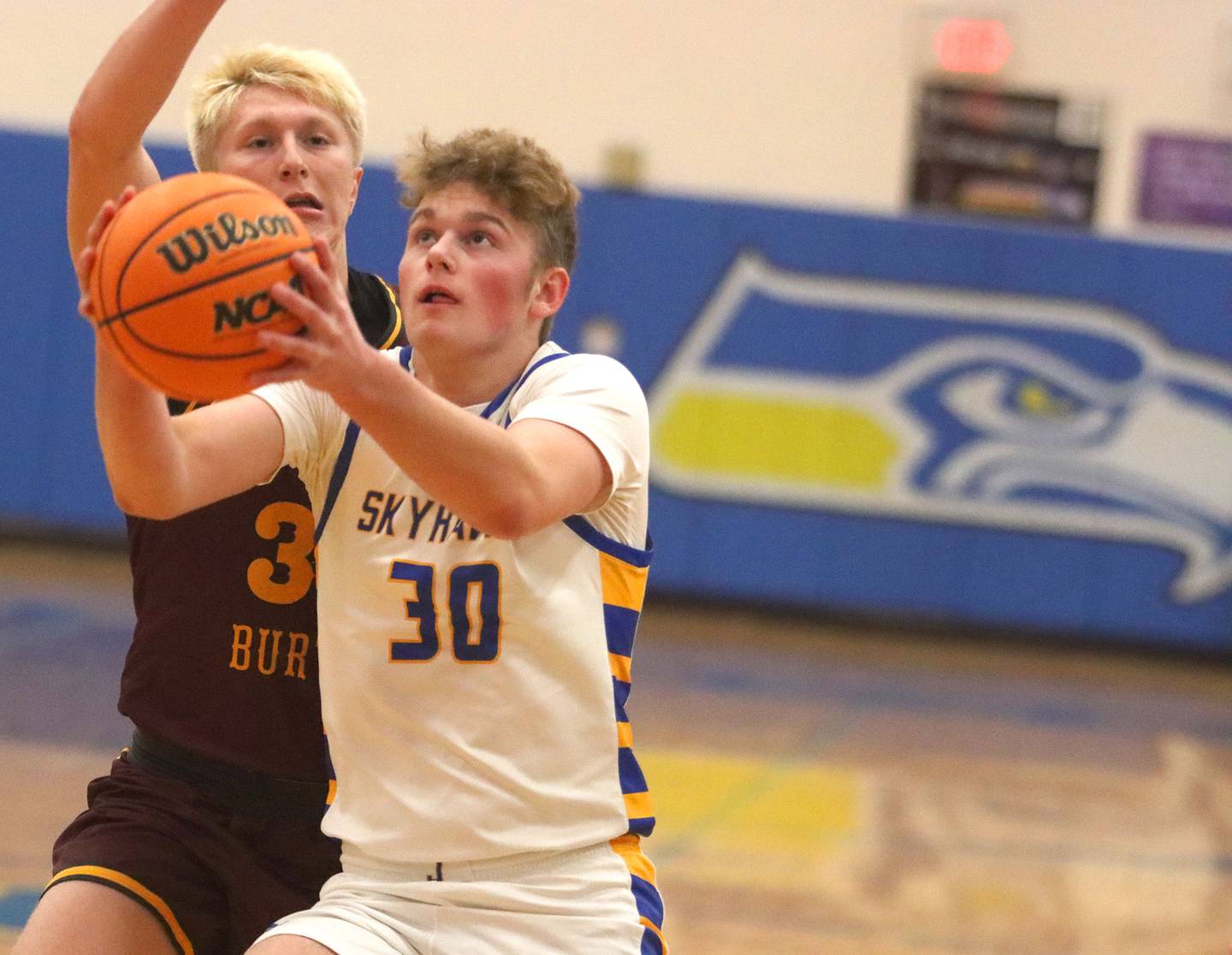 Johnsburg’s Jayce Schmitt gets past Richmond-Burton’s Luke Robinson in varsity boys basketball onTuesday, Dec. 9, 2025, at Johnsburg High School in Johnsburg.