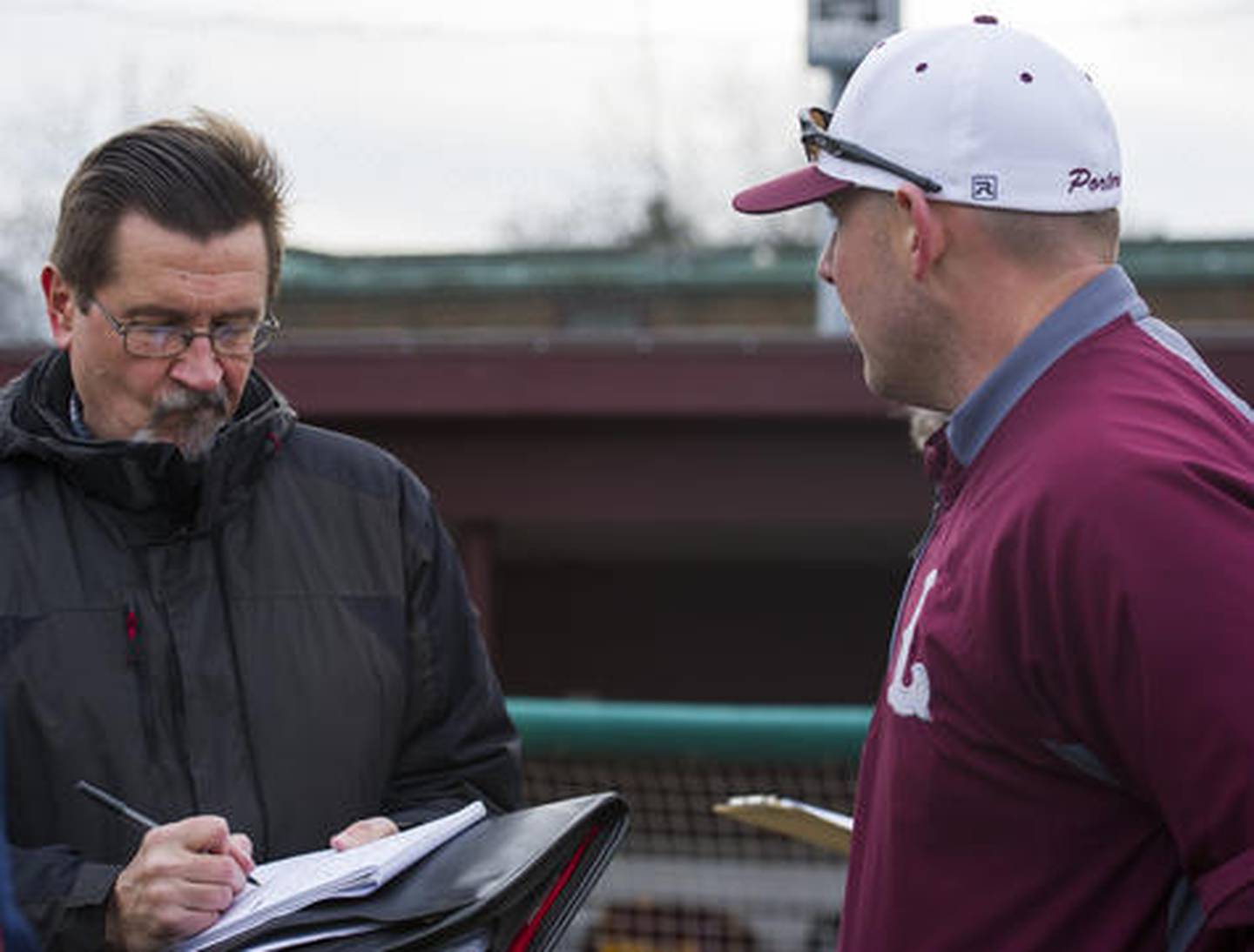 Joliet Herald News sports reporter Dick Goss interviews Lockport Head Coach Andy Satunas Saturday at Ed Flink Field in Lockport.