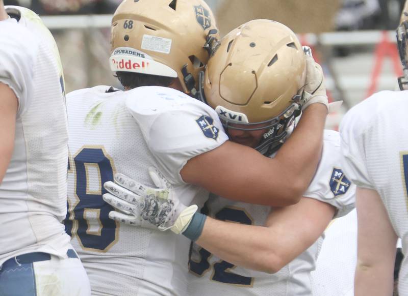Marquette's Alex Schaefer hugs teammate Grant Dose after loosing during the Class 1A playoff game on Saturday, Nov. 1, 2025 at Gibson City-Melvin-Sibley High School.