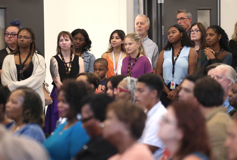 Members of the new school’s faculty listen Friday, Aug. 8, 2025, as Leroy Mitchell speaks during the grand opening celebration for the school that bears his name, Dr. Leroy A. Mitchell Elementary School in DeKalb.