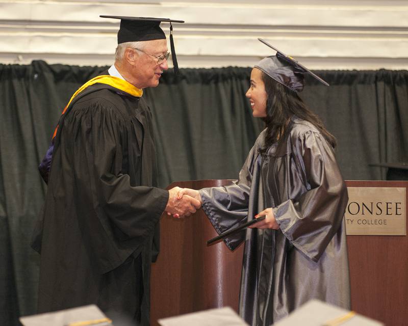 Batavia resident Annette Heiser receives her diploma from Waubonsee Community College Board of Trustees Chair Richard “Shorty” Dickson at the college’s 45th annual commencement ceremony on Thursday. (Photo provided)
